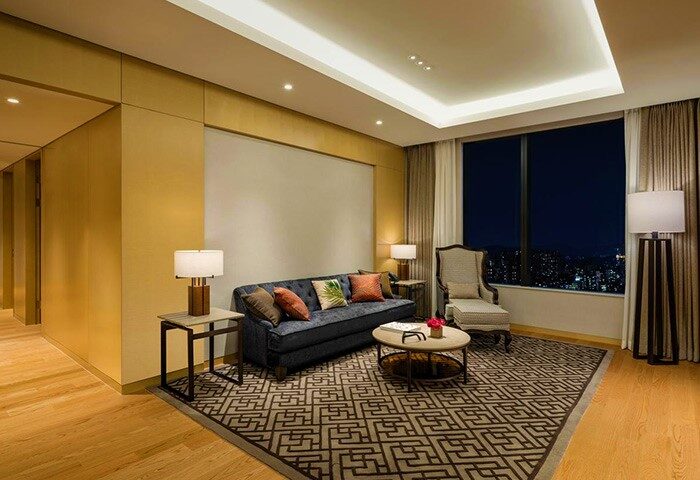 Grand Mercure Ambassador Hotel Seoul Yongsan suite. Gay-friendly hotel with city views, sofa, chair, and stylish decor for gay travelers.