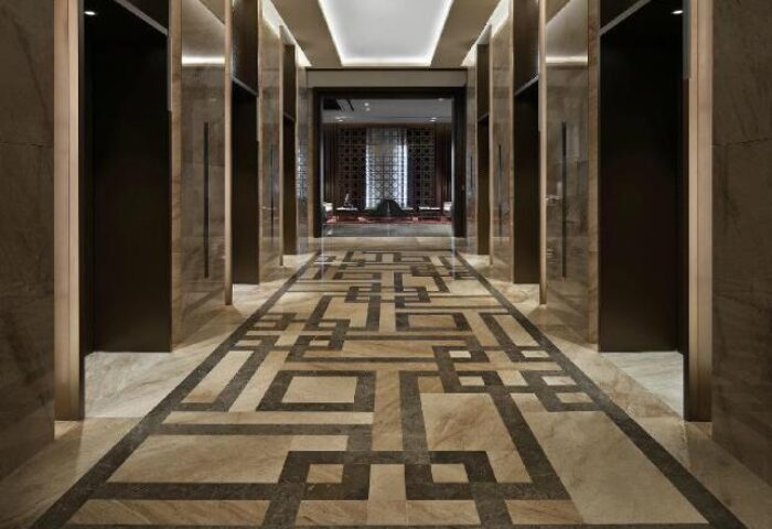 Grand Mercure Ambassador Hotel & Residences Seoul Yongsan corridor. Geometric patterned floor. Gay-friendly hotel design. Modern, luxurious.