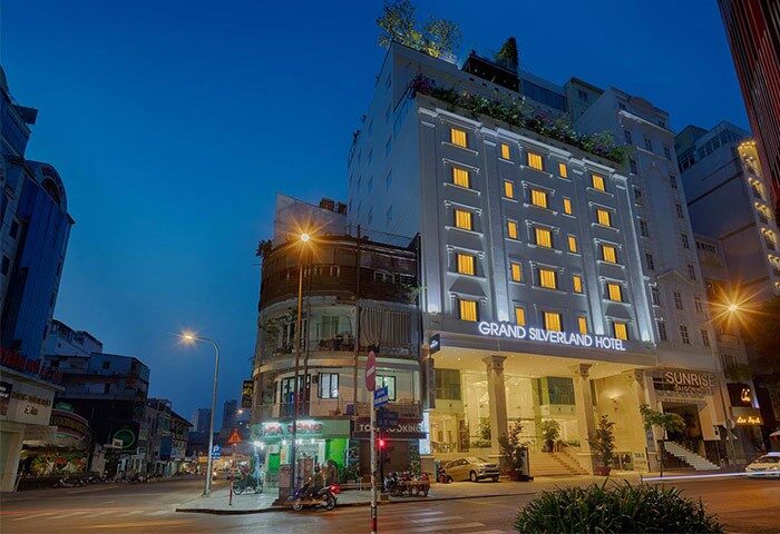 Grand Silverland Hotel, a gay-friendly hotel, at night. Exterior view of the hotel with street view. Saigon, Vietnam.