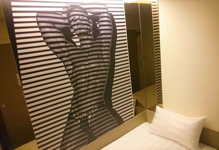 Gs Gay Hotel room. Wall art of a shirtless man in briefs with horizontal stripes. Gay-Friendly Hotel decor for gay men travel advice.