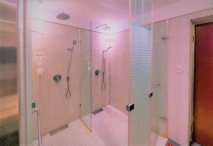 Gs Gay Hotel's shower area. Modern, tiled showers with glass partitions. Gay-friendly hotel design. Ideal for gay men travelers.
