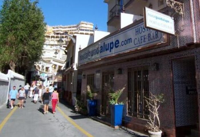 Guadalupe Cozy Inns: Street view of gay-friendly hotel. People walk past Hostal Guadalupe's cafe/bar. A great spot for gay travel in Guadalupe.