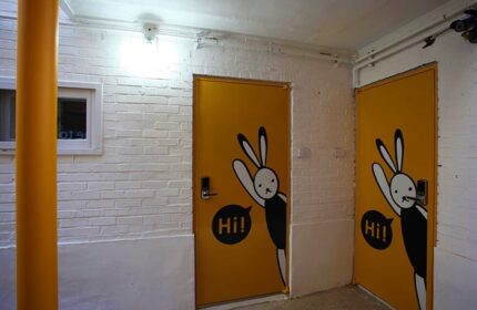 Guest House DODAMi: Two yellow doors with a bunny design. Gay-friendly hotel with unique decor for gay men travelers. Interior view.