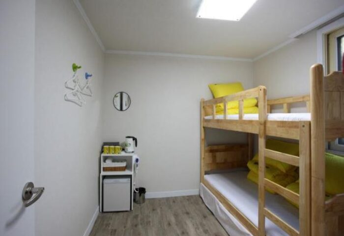 Guest House DODAMi's room. Gay-friendly hotel with bunk beds, mini fridge, kettle, and hangers. Ideal for gay men travelers in Korea.