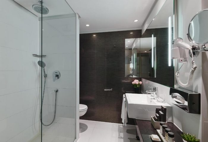 H10 Berlin Ku'damm Hotel bathroom. Modern design with shower, sink, and amenities. Gay-friendly hotel in Berlin, Germany.