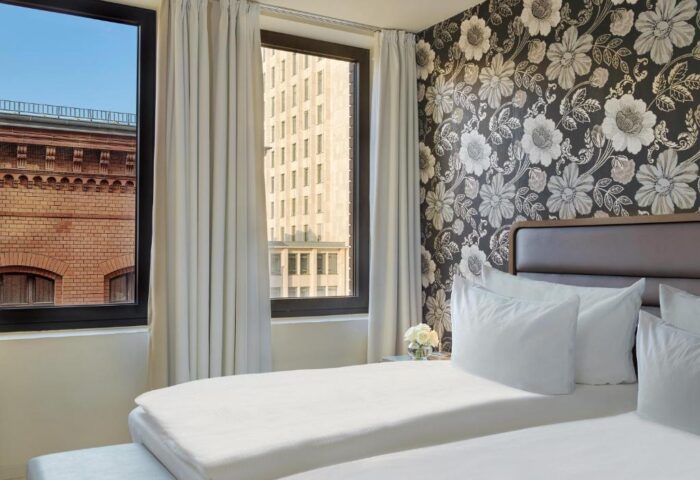 H10 Berlin Ku'damm Hotel room. Gay-friendly hotel with twin beds, floral wallpaper, and views of Berlin. Kudamm hotel for gay travelers.