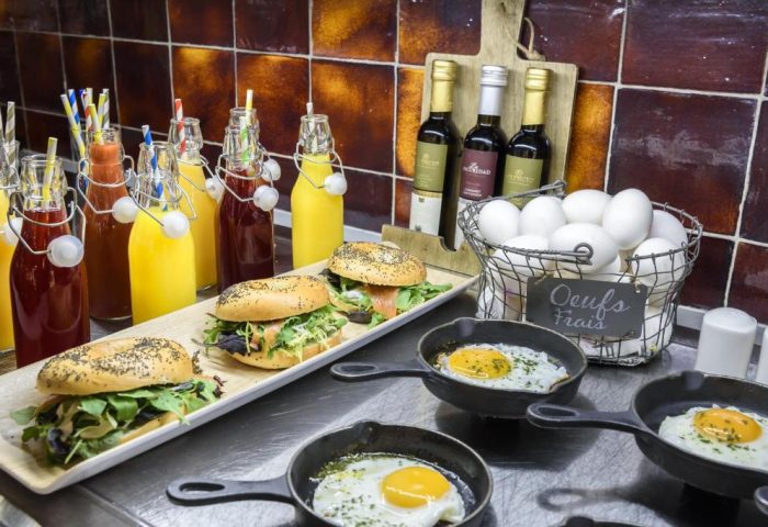 Breakfast buffet at H10 Villa de la Reina Boutique Hotel, a gay-friendly hotel. Fresh juices, bagels, and eggs. Madrid, Spain.