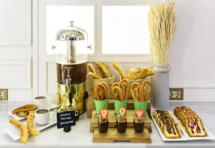 H10 Villa de la Reina Boutique Hotel's churro bar. Gay-friendly hotel breakfast buffet with churros, chocolate, and cake. Delicious!