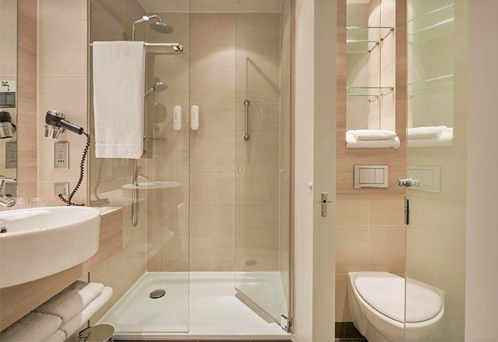 H2 Hotel Berlin-Alexanderplatz bathroom. Modern shower, sink, and toilet. Gay-friendly hotel with clean, well-lit facilities. Perfect for gay travel.