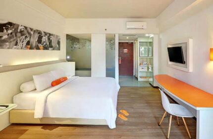HARRIS Hotel Seminyak room. Modern interior with bed, desk, and TV. Gay-friendly hotel for travelers in Seminyak, Bali.
