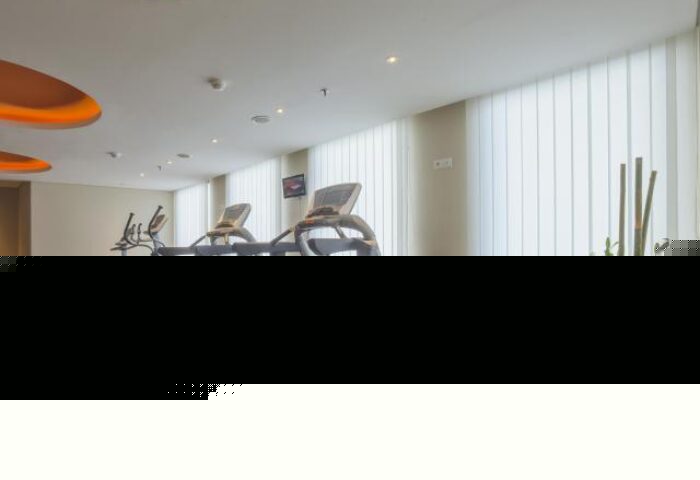 Gym at HARRIS Hotel Seminyak, a gay-friendly hotel. Treadmills, exercise bike, and weight bench. Fitness center for gay travelers in Seminyak.