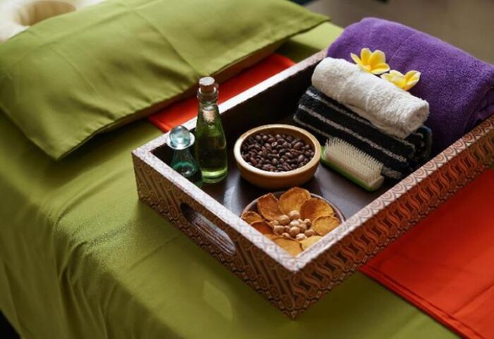 Gay-friendly HARRIS Hotel Tebet spa tray. Coffee beans, oils, towels, and snacks on a massage table. Relax at this Jakarta hotel.