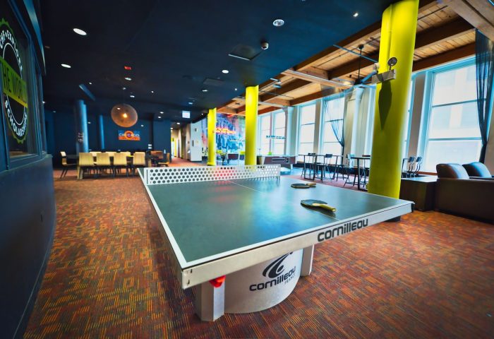 HI Chicago Hostel's game room. Ping pong table in a gay-friendly hotel. Fun communal space for travelers, perfect for socializing.