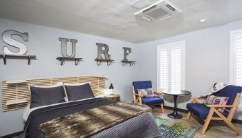 HI Los Angeles Santa Monica Hostel bedroom. Gay-friendly hotel room with SURF letters and modern decor for gay travelers.