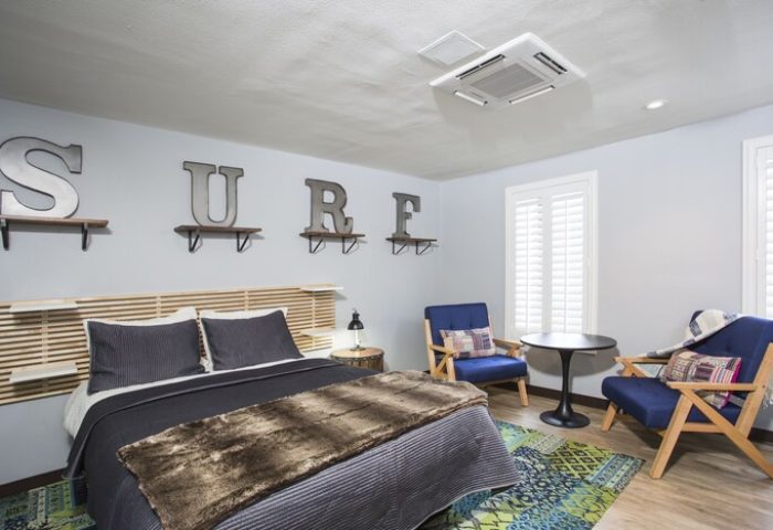 HI Los Angeles Santa Monica Hostel bedroom. Gay-friendly hotel room with SURF letters and modern decor for gay travelers.