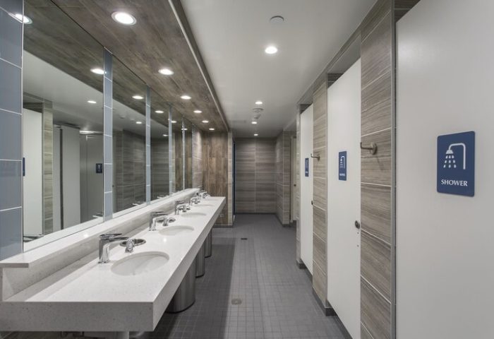 HI Los Angeles Santa Monica Hostel's bathroom. Gay-friendly hotel with modern sinks, mirrors, and shower stalls. Great for gay travel.