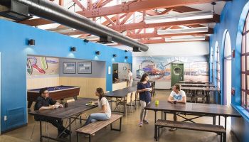 HI Los Angeles Santa Monica Hostel's common area. Gay-friendly hotel with pool table, tables, and Santa Monica mural. Great hostel!