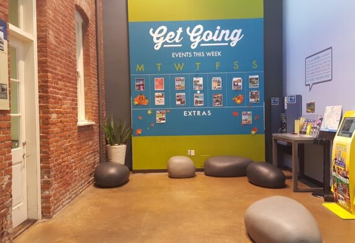 HI Los Angeles Santa Monica Hostel interior. Gay-friendly hotel with event calendar, info kiosk, and brick wall. Great for gay travel.