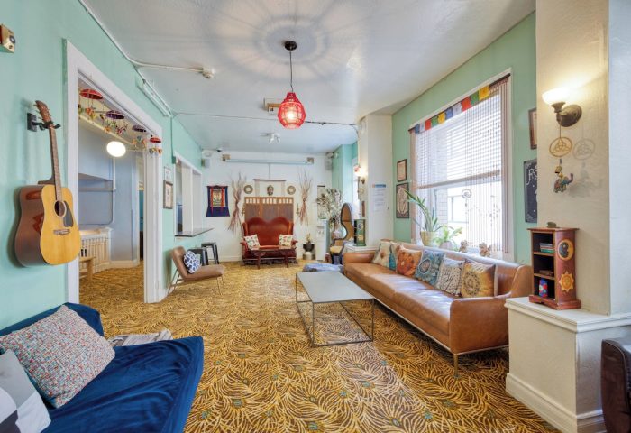 HI San Francisco Downtown Hostel's common area. A guitar hangs on the wall. Gay-friendly hotel with a social atmosphere.