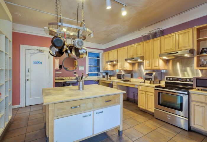 HI San Francisco Downtown Hostel kitchen. Gay-friendly hotel with stainless steel appliances, cookware, and an island. Ideal for gay travelers.