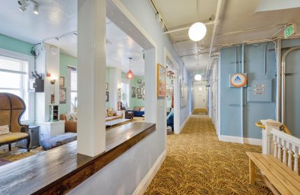 HI San Francisco Downtown Hostel interior. Gay-friendly hotel with a cozy lounge area and hallway. Great for gay men travel.