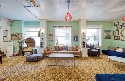 HI San Francisco Downtown Hostel's lounge area. Gay-friendly hotel with colorful decor, sofas, and a relaxed atmosphere. Perfect for LGBT travel.