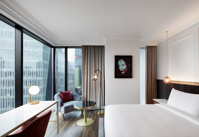HONEYROSE Hotel, a Tribute Portfolio Hotel, Montreal. Gay-friendly hotel room with city view, desk, chair, and modern art.