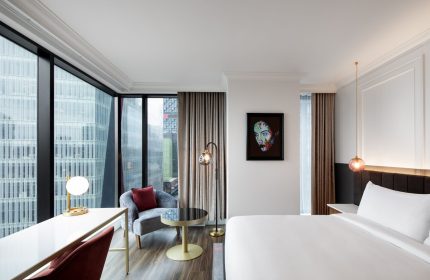HONEYROSE Hotel, a Tribute Portfolio Hotel, Montreal. Gay-friendly hotel room with city view, desk, chair, and modern art.