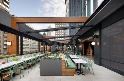 HONEYROSE Hotel Montreal's gay-friendly rooftop terrace. Outdoor seating, plants, city views. A Tribute Portfolio Hotel experience.