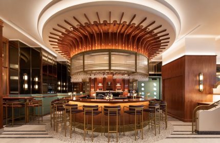 HONEYROSE Hotel Montreal bar. Gay-friendly Tribute Portfolio Hotel with circular bar, stylish lighting, and glasses. A great place to meet.