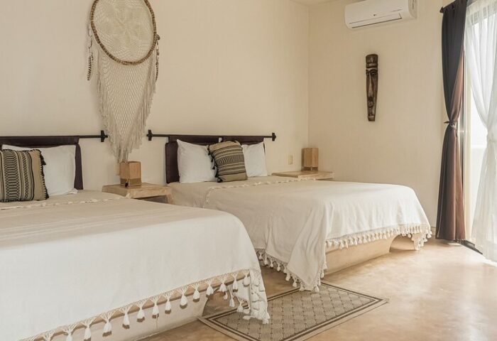 HOTEL POSADA 06 TULUM adults only room. Two beds, dream catcher, and ethnic decor. Gay-friendly hotel in Tulum for gay men's travel.