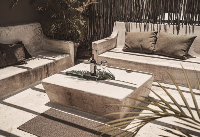 HOTEL POSADA 06 TULUM ADULTS ONLY: Gay-friendly hotel lounge area with wine, glasses, and palm leaf on a stone table. Relaxing vibe.