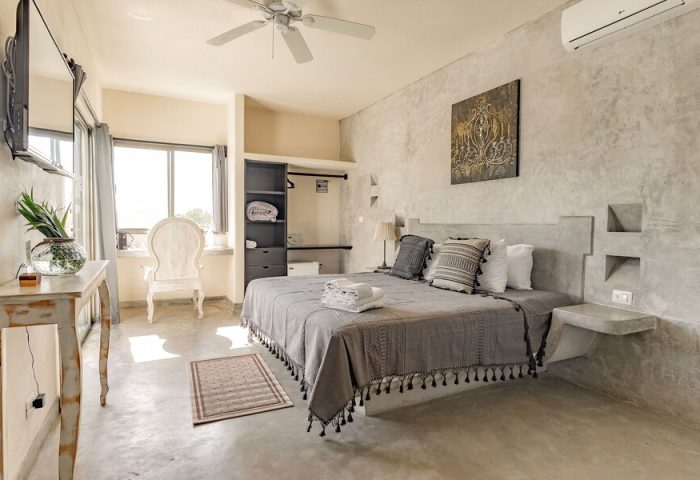 HOTEL POSADA 06 TULUM ADULTS ONLY gay-friendly hotel room. Modern design, king bed, concrete walls, ceiling fan, and natural light.