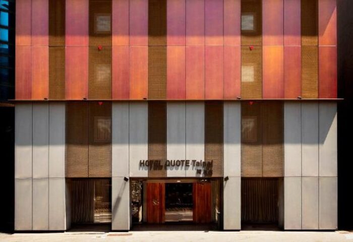HOTEL QUOTE Taipei facade. Gay-friendly hotel with modern design. Striped exterior with warm color palette. Taipei travel for gay men.