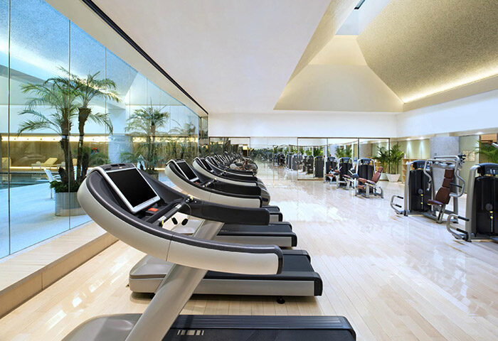 Gym at HUALUXE Shanghai Twelve At Hengshan, a gay-friendly hotel. Treadmills and weight machines offer a great workout.