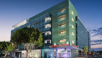 Hampton Inn & Suites Santa Monica, a gay-friendly hotel. Modern architecture, glass facade, and street view. A great choice for gay travelers.