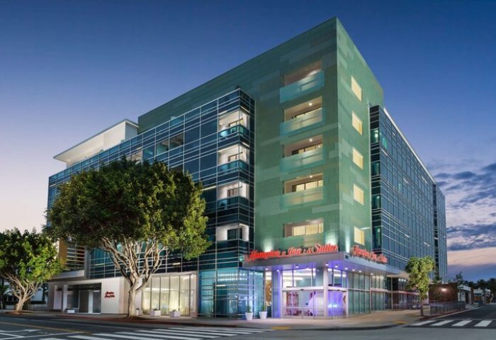 Hampton Inn & Suites Santa Monica, a gay-friendly hotel. Modern architecture, glass facade, and street view. A great choice for gay travelers.