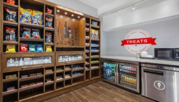 Hampton Inn & Suites by Hilton Toronto Downtown snack area. Gay-friendly hotel with treats, chips, chocolate, and drinks for visitors.