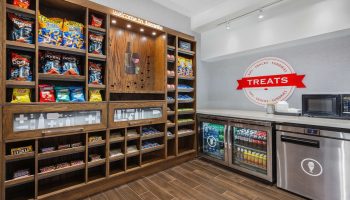 Hampton Inn & Suites by Hilton Toronto Downtown snack area. Gay-friendly hotel with treats, chips, chocolate, and drinks for visitors.