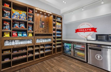 Hampton Inn & Suites by Hilton Toronto Downtown snack area. Gay-friendly hotel with treats, chips, chocolate, and drinks for visitors.