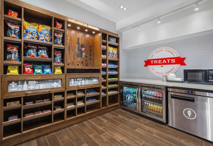 Hampton Inn & Suites by Hilton Toronto Downtown snack area. Gay-friendly hotel with treats, chips, chocolate, and drinks for visitors.