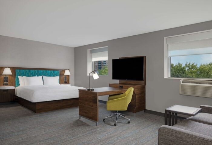 Hampton Inn & Suites by Hilton Toronto Downtown guest room. Modern decor, king bed, desk, and TV. Gay-friendly hotel in Toronto.