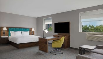 Hampton Inn & Suites by Hilton Toronto Downtown guest room. Modern decor, king bed, desk, and TV. Gay-friendly hotel in Toronto.