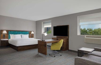 Hampton Inn & Suites by Hilton Toronto Downtown guest room. Modern decor, king bed, desk, and TV. Gay-friendly hotel in Toronto.