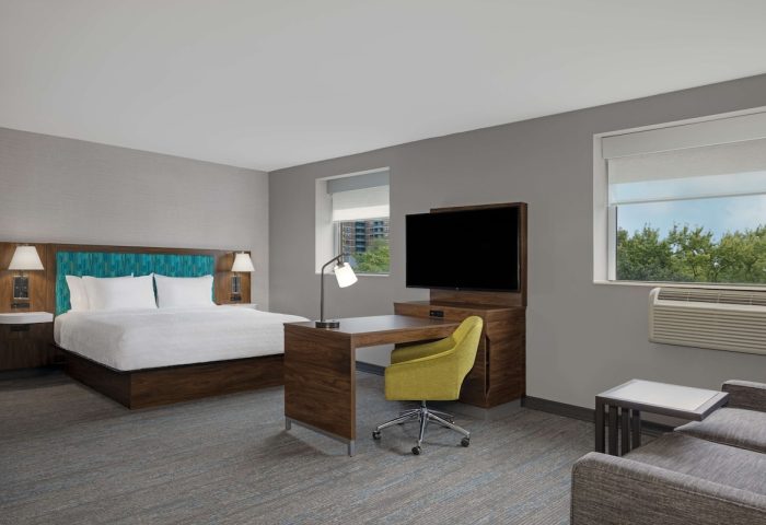 Hampton Inn & Suites by Hilton Toronto Downtown guest room. Modern decor, king bed, desk, and TV. Gay-friendly hotel in Toronto.