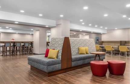 Hampton Inn & Suites by Hilton Toronto Downtown lobby seating area. Gay-friendly hotel with modern design and comfortable spaces.