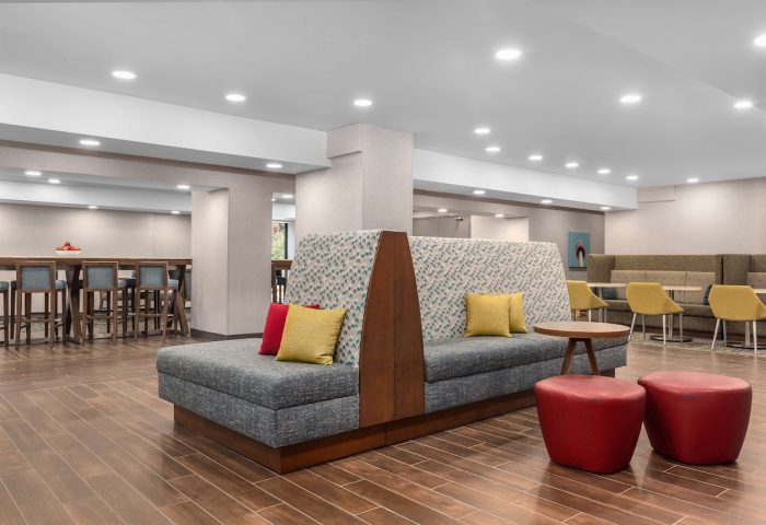 Hampton Inn & Suites by Hilton Toronto Downtown lobby seating area. Gay-friendly hotel with modern design and comfortable spaces.