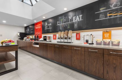 Breakfast bar at Hampton Inn & Suites by Hilton Toronto Downtown, a gay-friendly hotel. Cereal, waffles, and dietary needs info available.