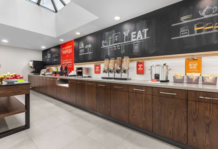Breakfast bar at Hampton Inn & Suites by Hilton Toronto Downtown, a gay-friendly hotel. Cereal, waffles, and dietary needs info available.