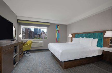 Hampton Inn & Suites by Hilton Toronto Downtown room. King bed, desk, TV, and city view. Gay-friendly hotel.